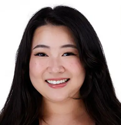 Asian woman with long brown hair smiling.